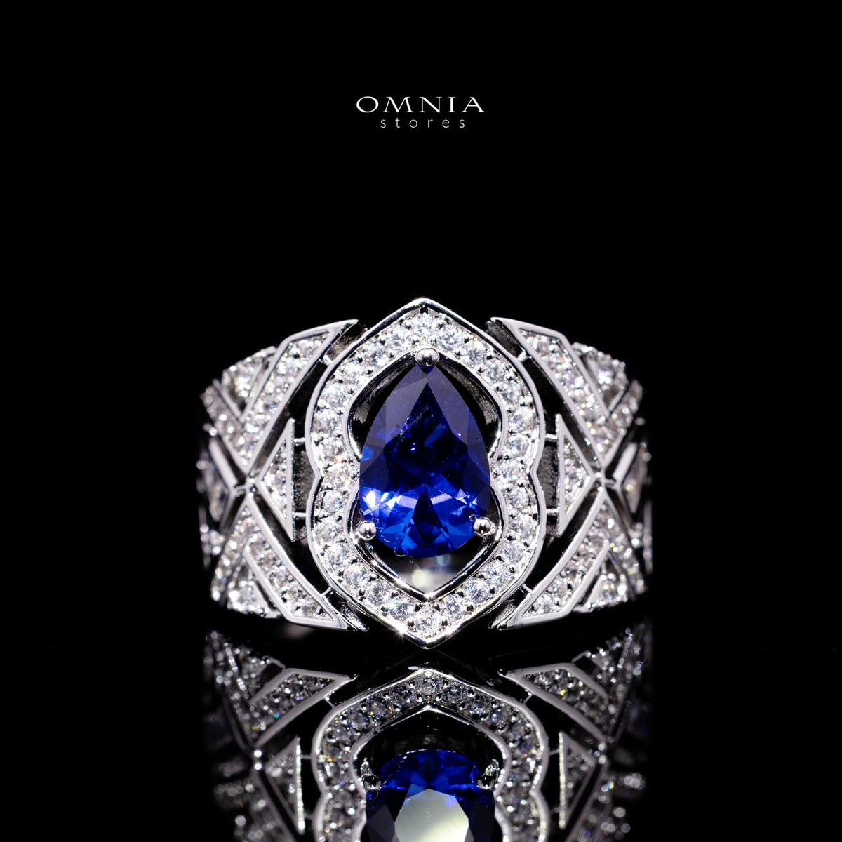 Omnia Daryan bridal statement ring featuring a blue teardrop-shaped zircon stone surrounded by clear stones