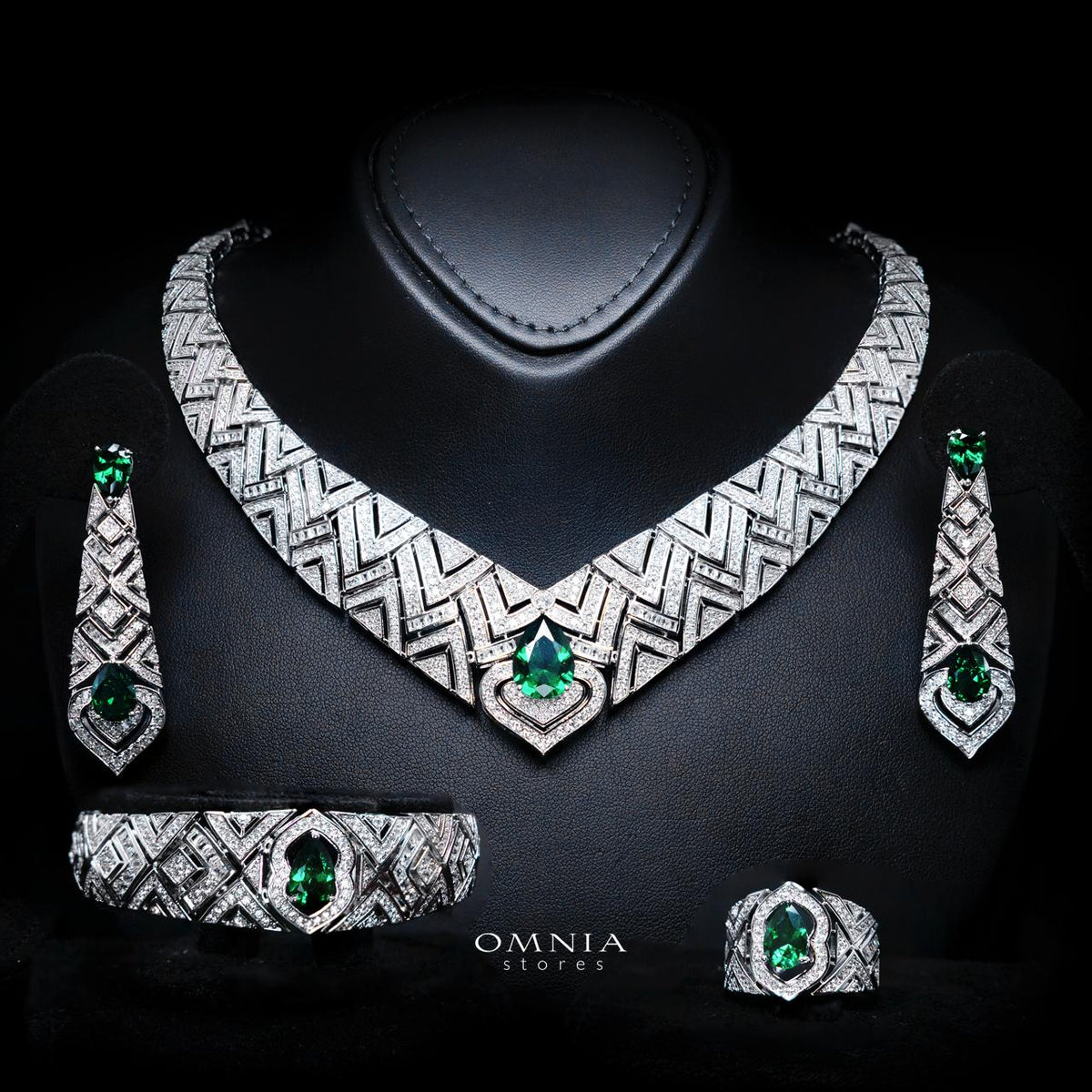 Omnia Daryan rhodium-plated bridal jewellery set featuring a necklace, earrings, bracelet and ring with green zircon accents