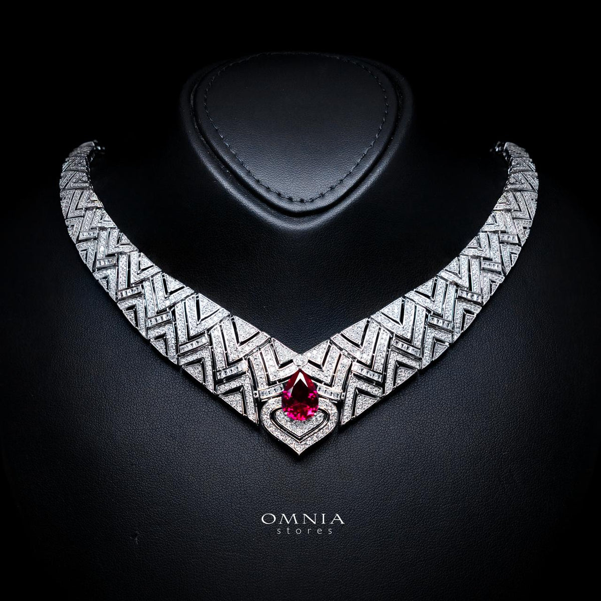 Omnia Daryan bridal necklace with geometric detailing and a red teardrop-shaped zircon centre stone