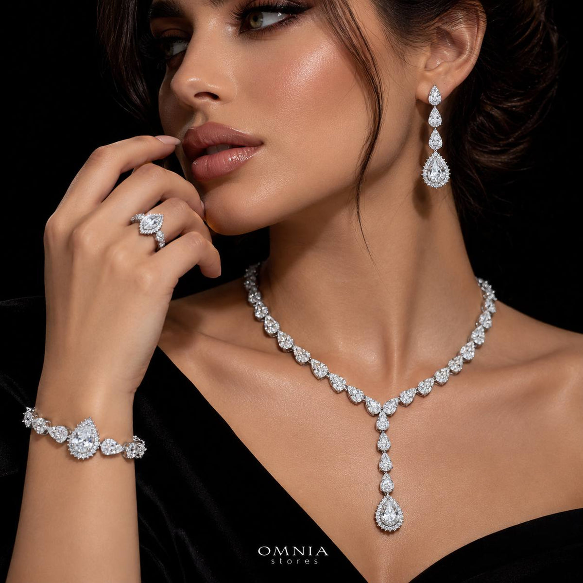 Model wearing the Omnia Radya white zircon bridal jewellery set with teardrop necklace, earrings, bracelet and ring