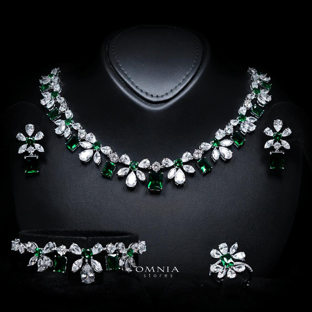 Omnia Rizza rhodium-plated bridal jewellery set with green zircon accents, including necklace, earrings, bracelet and ring