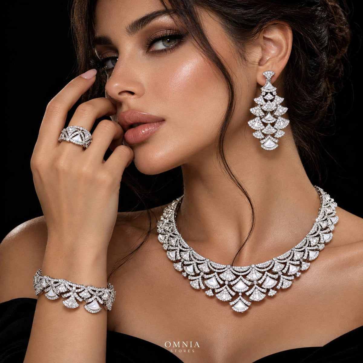 Model wearing the Omnia Bita white zircon bridal jewellery set with necklace, earrings, bracelet and ring