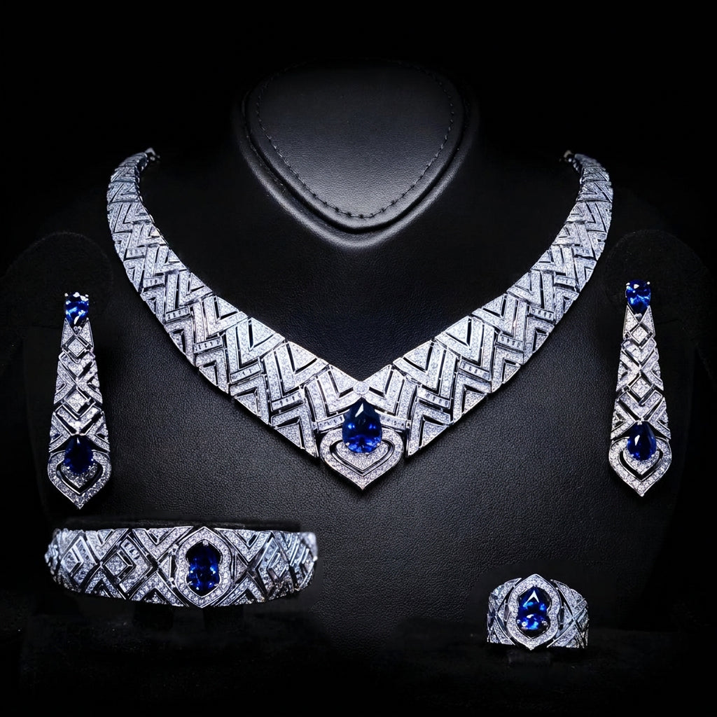 Omnia Daryan rhodium-plated bridal jewellery set featuring a necklace, earrings, bracelet and ring with blue zircon accents
