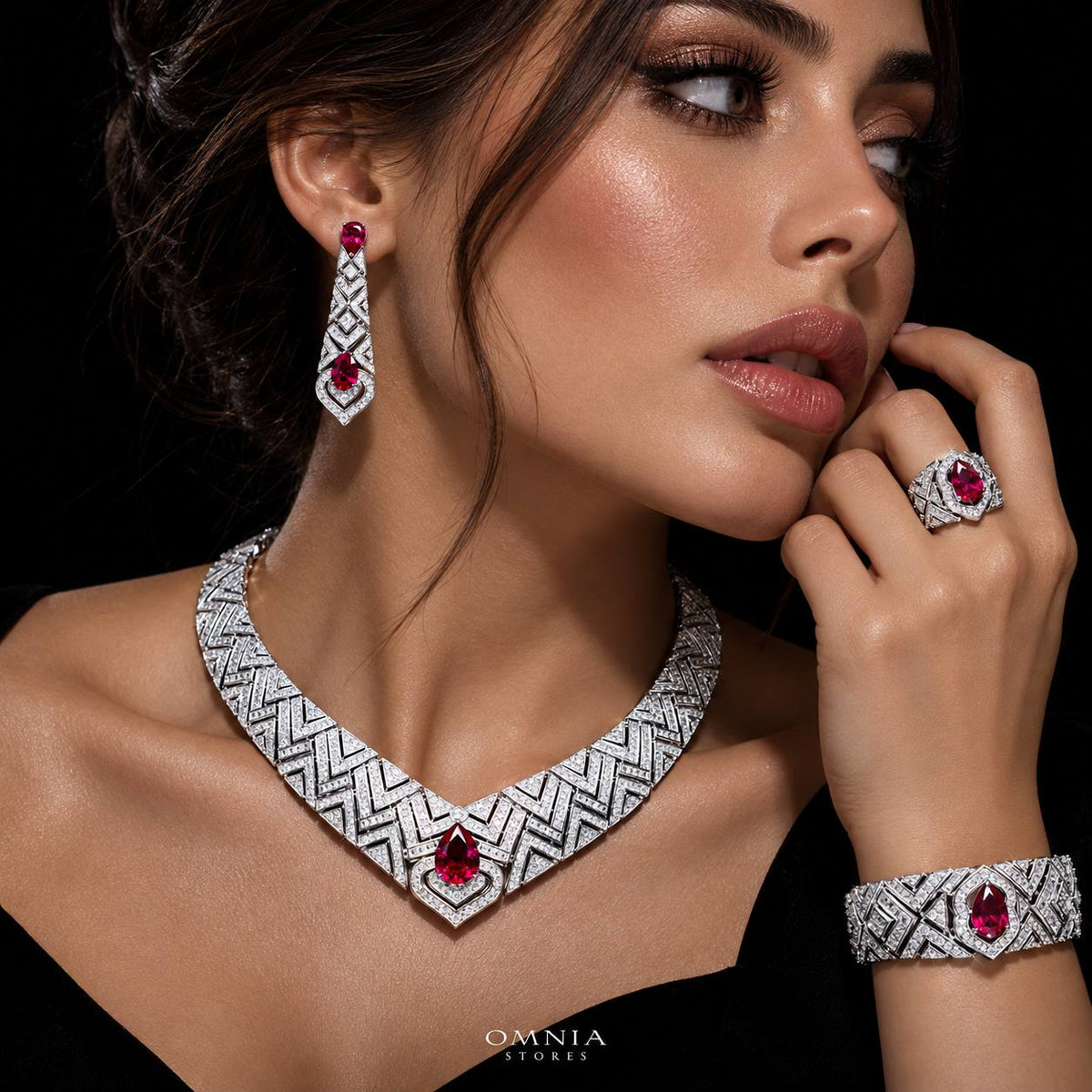 Model wearing the Omnia Daryan red zircon bridal jewellery set with necklace, earrings, bracelet and ring