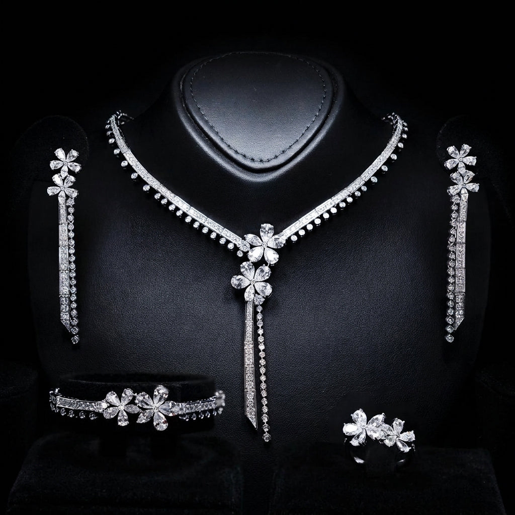 Omnia Emmeline rhodium-plated bridal jewellery set with white zircon floral designs, including necklace, earrings, bracelet and ring