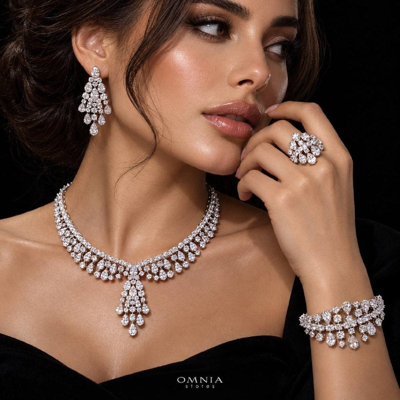 Model wearing the Omnia Minerva zircon bridal jewellery set with a drop necklace, chandelier earrings, bracelet and ring