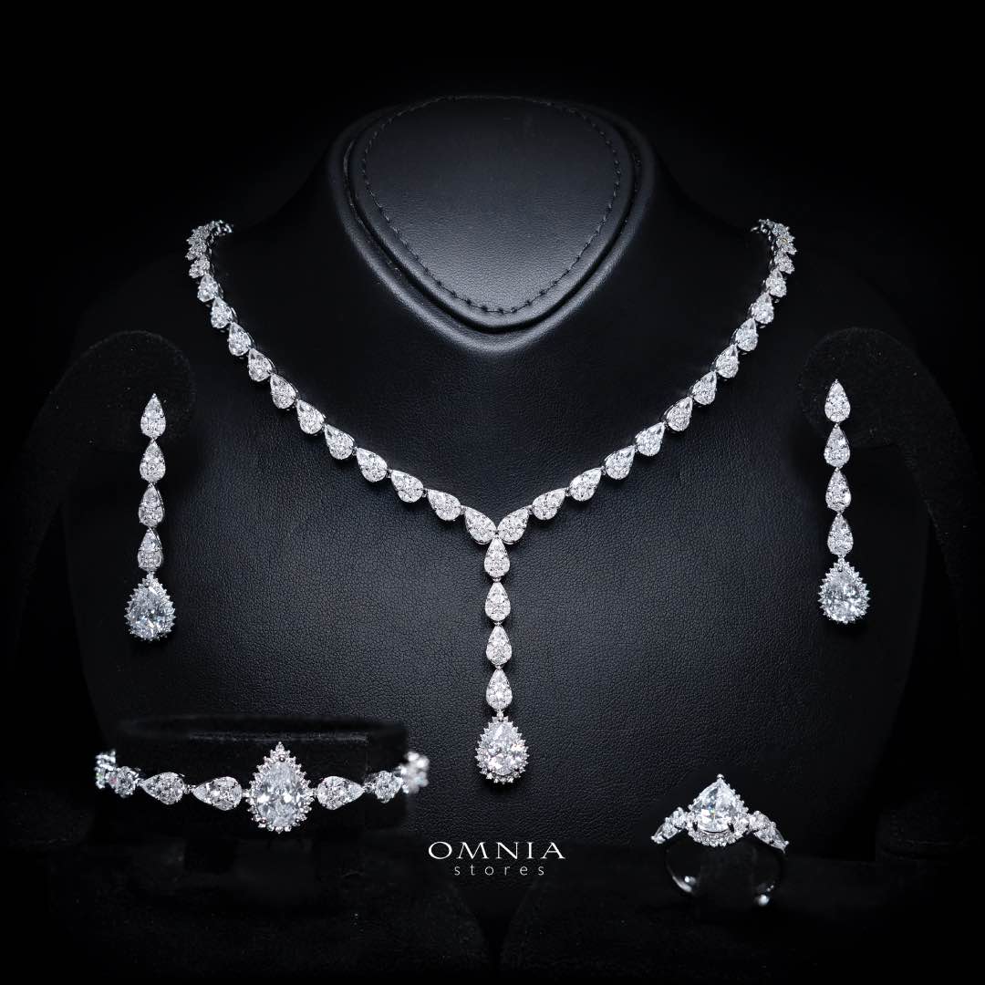 Omnia Radya rhodium-plated bridal jewellery set with white zircon teardrop designs, including necklace, earrings, bracelet and ring
